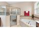 Bathroom features a corner soaking tub, walk-in shower, and double vanity at 1105 Gardenshire Ln, Deland, FL 32724