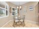 Bright breakfast nook with glass table and metal chairs, adjacent to kitchen at 1105 Gardenshire Ln, Deland, FL 32724