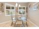 Bright breakfast nook features a glass table and four metal chairs at 1105 Gardenshire Ln, Deland, FL 32724