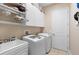 Laundry room with washer, dryer, and cabinets at 1105 Gardenshire Ln, Deland, FL 32724