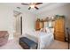 Main bedroom with a king-size bed, built-in wooden cabinets and ceiling fan at 1105 Gardenshire Ln, Deland, FL 32724