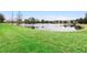 Serene pond view with lush green landscaping at 1105 Gardenshire Ln, Deland, FL 32724