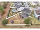 Aerial view of house, yard, pool, and surrounding neighborhood at 1106 Woods Landing Dr, Minneola, FL 34715