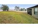 Spacious backyard with large grassy area, shed, and playset at 1106 Woods Landing Dr, Minneola, FL 34715