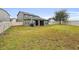 Large backyard with green grass and a basketball hoop at 1106 Woods Landing Dr, Minneola, FL 34715