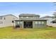 Large backyard with screened porch, grassy area, and basketball hoop at 1106 Woods Landing Dr, Minneola, FL 34715