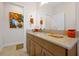 Elegant bathroom with granite countertop, single sink and built-in cabinets at 1106 Woods Landing Dr, Minneola, FL 34715