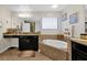 Spa-like bathroom with double vanity, soaking tub, and walk-in shower at 1106 Woods Landing Dr, Minneola, FL 34715