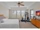 Spacious bedroom with ceiling fan, large windows, and home gym area at 1106 Woods Landing Dr, Minneola, FL 34715