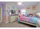 Charming bedroom with a dresser and a bed, featuring a colorful decor at 1106 Woods Landing Dr, Minneola, FL 34715
