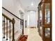 Bright and spacious entryway with staircase and display cabinet at 1106 Woods Landing Dr, Minneola, FL 34715