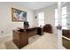 Spacious home office with a large desk and neutral color scheme at 1106 Woods Landing Dr, Minneola, FL 34715