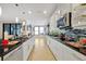 Open kitchen boasting a large island, updated appliances, and white cabinets at 1106 Woods Landing Dr, Minneola, FL 34715
