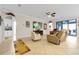 Open living room with a ceiling fan, large TV, and comfortable seating at 1106 Woods Landing Dr, Minneola, FL 34715