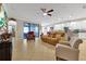 Open concept living room with access to the kitchen and backyard at 1106 Woods Landing Dr, Minneola, FL 34715
