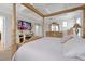 Spacious main bedroom, features a large bed, TV and fireplace at 1106 Woods Landing Dr, Minneola, FL 34715
