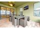 Outdoor patio with a glass-top table and wicker chairs at 1106 Woods Landing Dr, Minneola, FL 34715