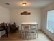 Small dining area with white table and chairs at 119 No Name Key Dr, Deland, FL 32720