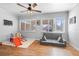 Versatile playroom with hardwood floors, a ceiling fan, and ample natural light at 120 E Holly Dr, Orange City, FL 32763