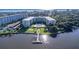 Aerial view of waterfront property with pool and tennis courts at 1224 S Peninsula Dr # 511, Daytona Beach, FL 32118