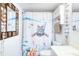 Bathroom with a nautical-themed shower curtain and white vanity at 1224 S Peninsula Dr # 511, Daytona Beach, FL 32118