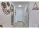 Bright entryway with tiled floor, white door, and coastal-themed wall art at 1224 S Peninsula Dr # 511, Daytona Beach, FL 32118