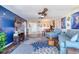 Living room with blue accent wall, hardwood floors, and comfortable seating at 1224 S Peninsula Dr # 511, Daytona Beach, FL 32118