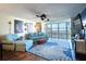 Living room boasts hardwood floors, blue sofas, and stunning river views at 1224 S Peninsula Dr # 511, Daytona Beach, FL 32118