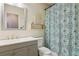 Bathroom featuring modern vanity, toilet, shower/tub, and decorative shower curtain at 1240 W Voorhis Ave, Deland, FL 32720