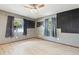 Bedroom featuring wood flooring, two windows and a ceiling fan at 1240 W Voorhis Ave, Deland, FL 32720