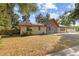 Charming single-story home boasts stone accents, solar panels, and a well-manicured lawn with mature trees at 1240 W Voorhis Ave, Deland, FL 32720