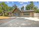 Charming single-story home boasts stone accents, solar panels, and a long concrete driveway for easy parking at 1240 W Voorhis Ave, Deland, FL 32720