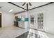 Bright kitchen with white cabinets, stainless steel appliances, and turquoise backsplash opens to outdoor patio at 1240 W Voorhis Ave, Deland, FL 32720