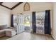 View of open front door with neutral decor, beamed ceilings, wood-look tile, and comfortable seating at 1240 W Voorhis Ave, Deland, FL 32720
