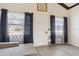 Cozy living room with wood floors, sofa, natural light from the windows, and dark curtains at 1240 W Voorhis Ave, Deland, FL 32720