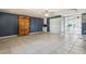 Living room with blue walls, tile floors, and a view into the kitchen at 1240 W Voorhis Ave, Deland, FL 32720