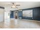Large living room with tile floors, ceiling fan, and front door at 1240 W Voorhis Ave, Deland, FL 32720