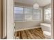 Modern bathroom featuring a free-standing tub and wood-look floors at 131 Wildwood Rd, Deland, FL 32720