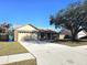 One-story house with a two-car garage and a spacious front yard at 1387 Hensley Dr, Deland, FL 32724