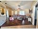 Living room features a sectional sofa and wood-look floors at 1387 Hensley Dr, Deland, FL 32724