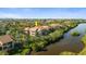 A serene view of a condominium complex nestled among lush greenery along the still waters of a pond at 1401 S Palmetto Ave # 614, Daytona Beach, FL 32114
