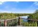Relaxing view of the lush green landscape from the wooden balcony with black iron railings at 1401 S Palmetto Ave # 614, Daytona Beach, FL 32114