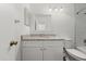 Bathroom features vanity with granite counter, mirror, light fixture, toilet and tub with white tile surround at 1401 S Palmetto Ave # 614, Daytona Beach, FL 32114