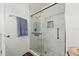Elegant bathroom featuring glass shower with white marbled tile surround, niche, and tiled floor at 1401 S Palmetto Ave # 614, Daytona Beach, FL 32114