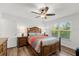Bright bedroom with a ceiling fan, hardwood floors, and large windows at 1401 S Palmetto Ave # 614, Daytona Beach, FL 32114