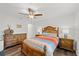 Bright bedroom with a ceiling fan, hardwood floors, and a decorative headboard at 1401 S Palmetto Ave # 614, Daytona Beach, FL 32114