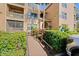 The apartment complex entrance features accessible ramps, flourishing greenery, and clear unit number signage at 1401 S Palmetto Ave # 614, Daytona Beach, FL 32114