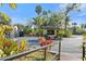 Gated entrance with lush landscaping and tropical foliage, providing privacy and a grand welcome to the community at 1401 S Palmetto Ave # 614, Daytona Beach, FL 32114