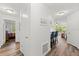 Hallway with hardwood flooring leading to bedrooms, dining area, and a breakfast bar at 1401 S Palmetto Ave # 614, Daytona Beach, FL 32114