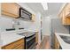 Well-lit kitchen featuring a black cooktop, stainless steel refrigerator, and white countertops at 1401 S Palmetto Ave # 614, Daytona Beach, FL 32114